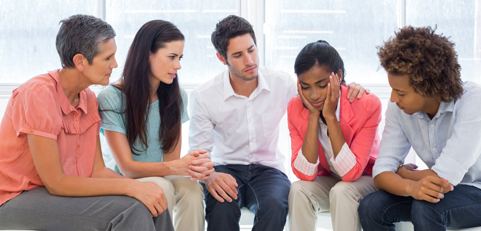 group of people supporting a depressed individual